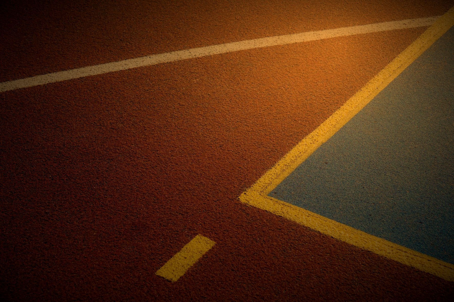 Painted lines on a worn outdoor court surface