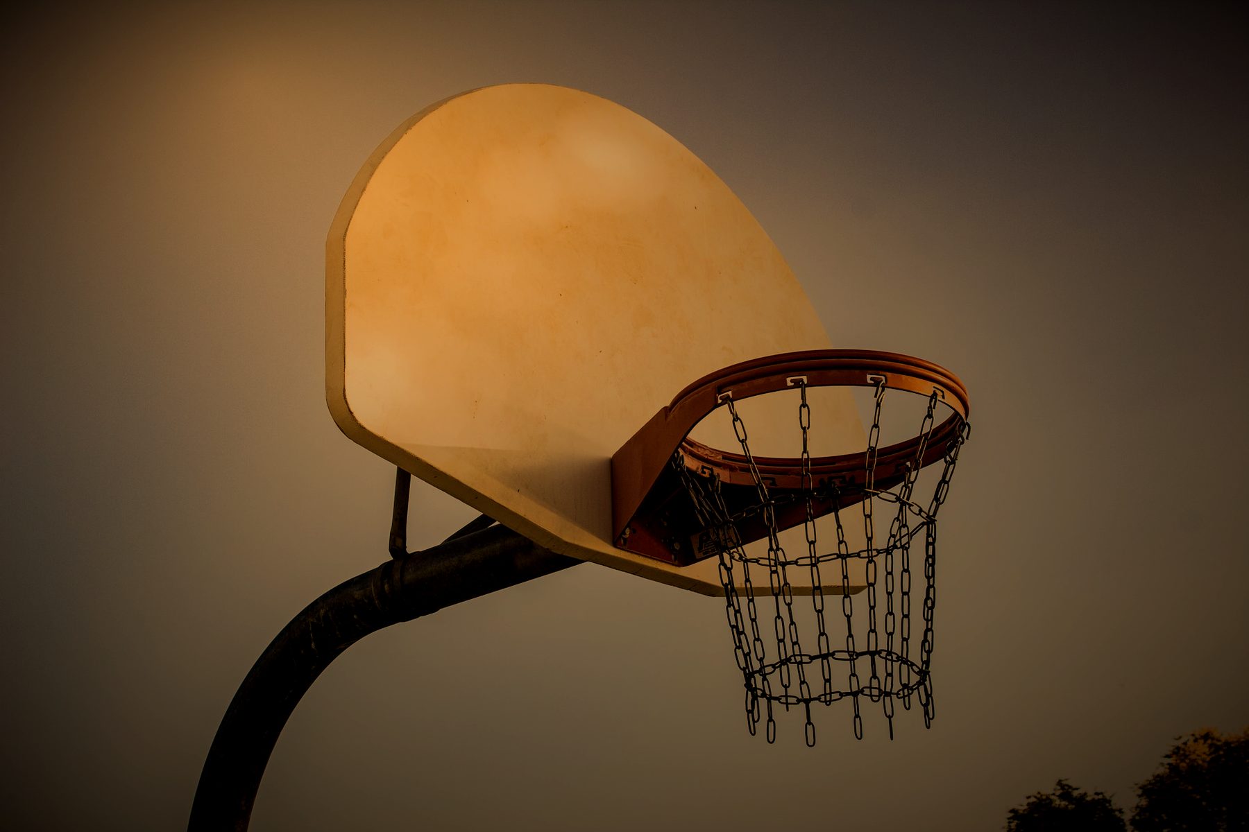 Outdoor backboard and rim against open sky