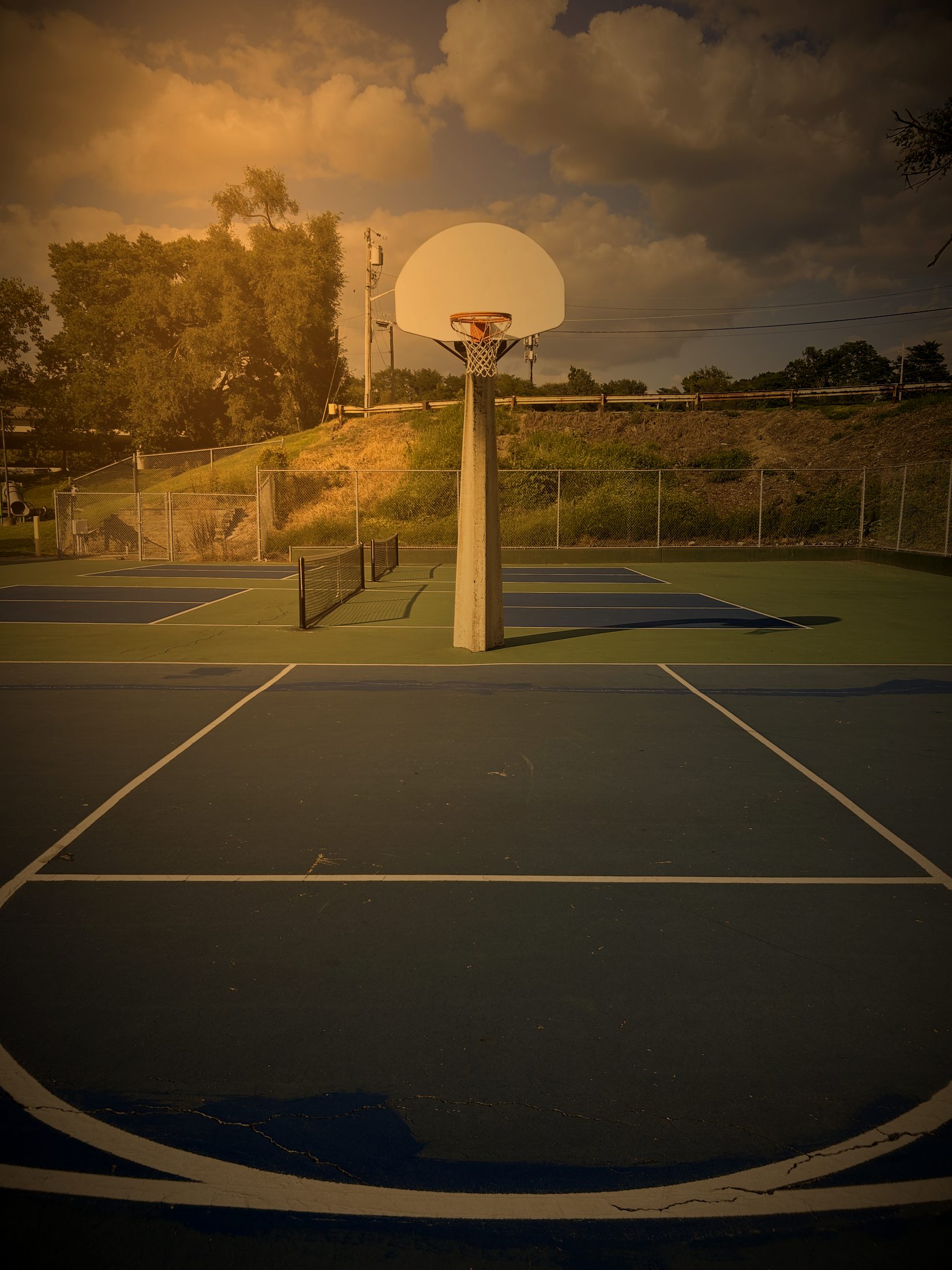 Blue and green outdoor hard court with a basketball hoop in Newport, Kentucky
